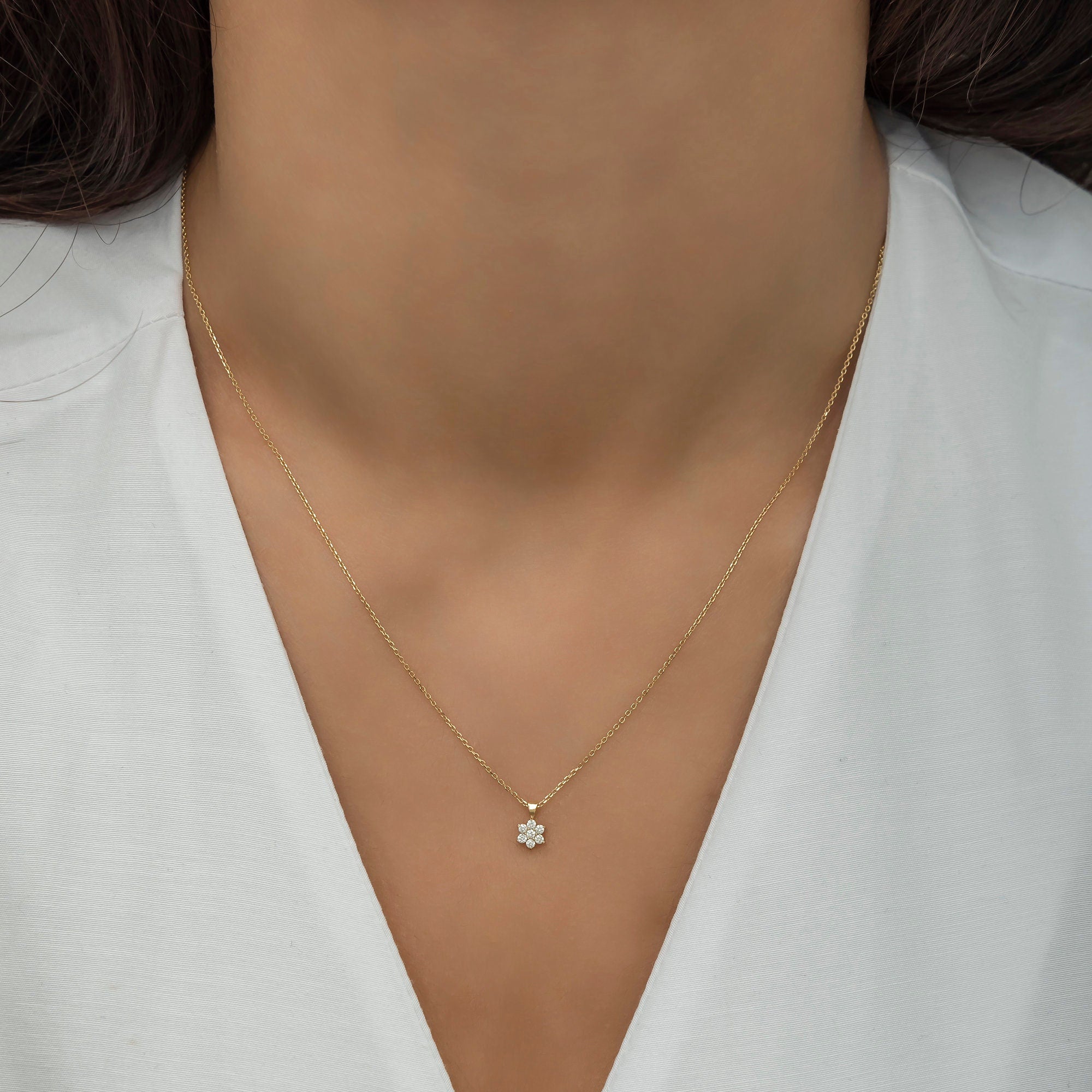 Elegant 14K gold necklace featuring a 5.50mm diamond-encrusted flower pendant, shown on the neckline. A delicate and timeless design that adds a touch of sparkle and sophistication, perfect for Christmas or special occasion gifts.