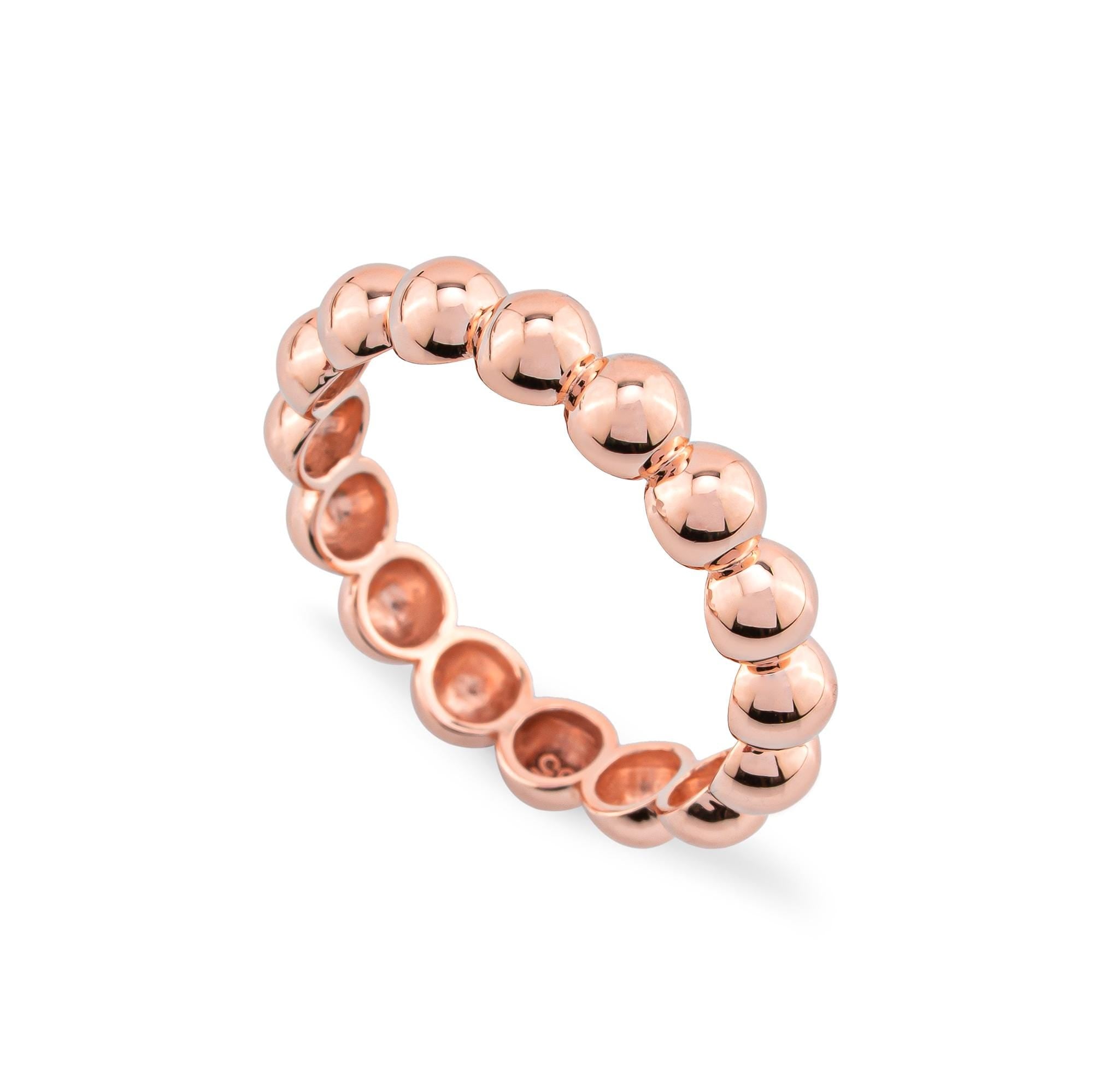 14K solid gold ball rings in 3mm and 4mm sizes, shown stacked on a finger in yellow gold. Perfect for creating an elegant and versatile layered look with a dainty beaded design.