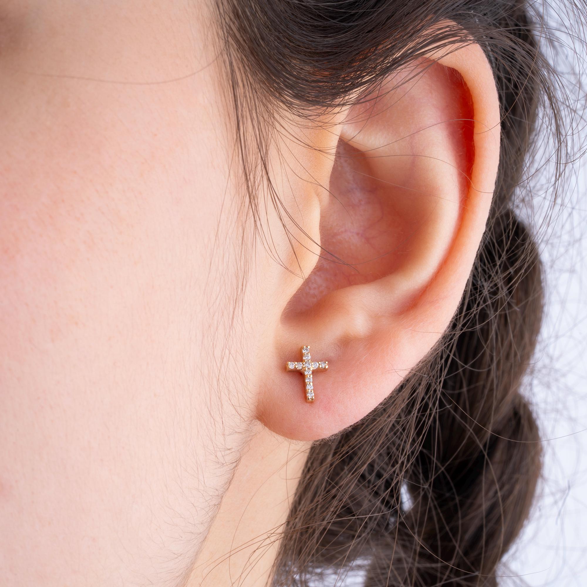 Elegant 14K gold diamond cross stud earrings for women, designed with 12 diamonds in a cross shape, a beautiful addition to any jewelry collection.
