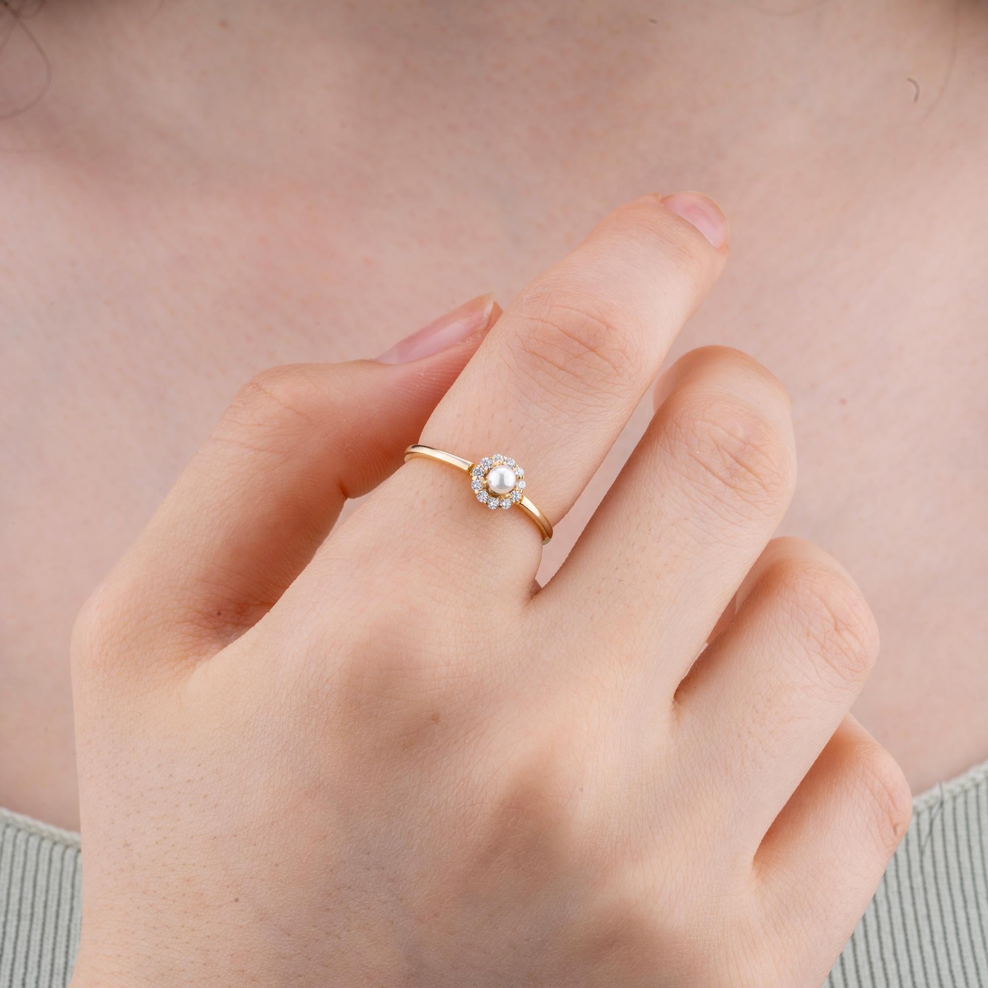 Handcrafted 14K Gold Pearl and Diamond Engagement Ring - This stunning ring showcases a 4mm pearl encircled by a dazzling diamond halo, perfect for engagements or promise rings.