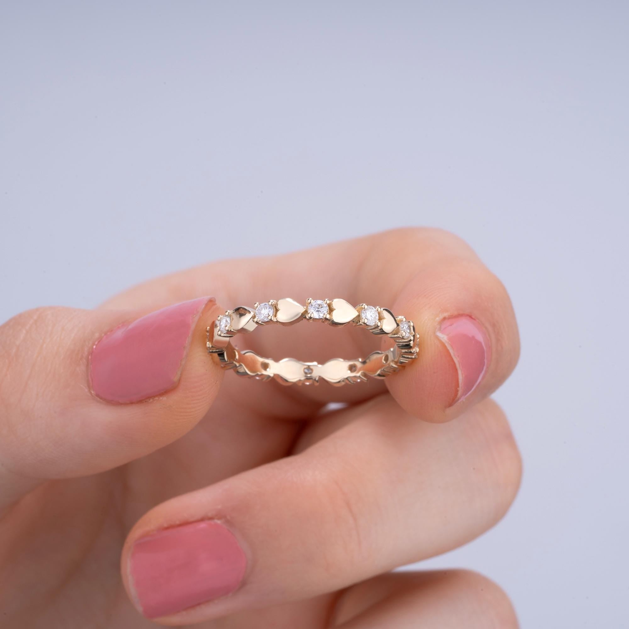 Dainty 14K gold diamond and heart band with a 0.40 Ctw diamond setting, perfect as a wedding ring, engagement band, or anniversary gift.