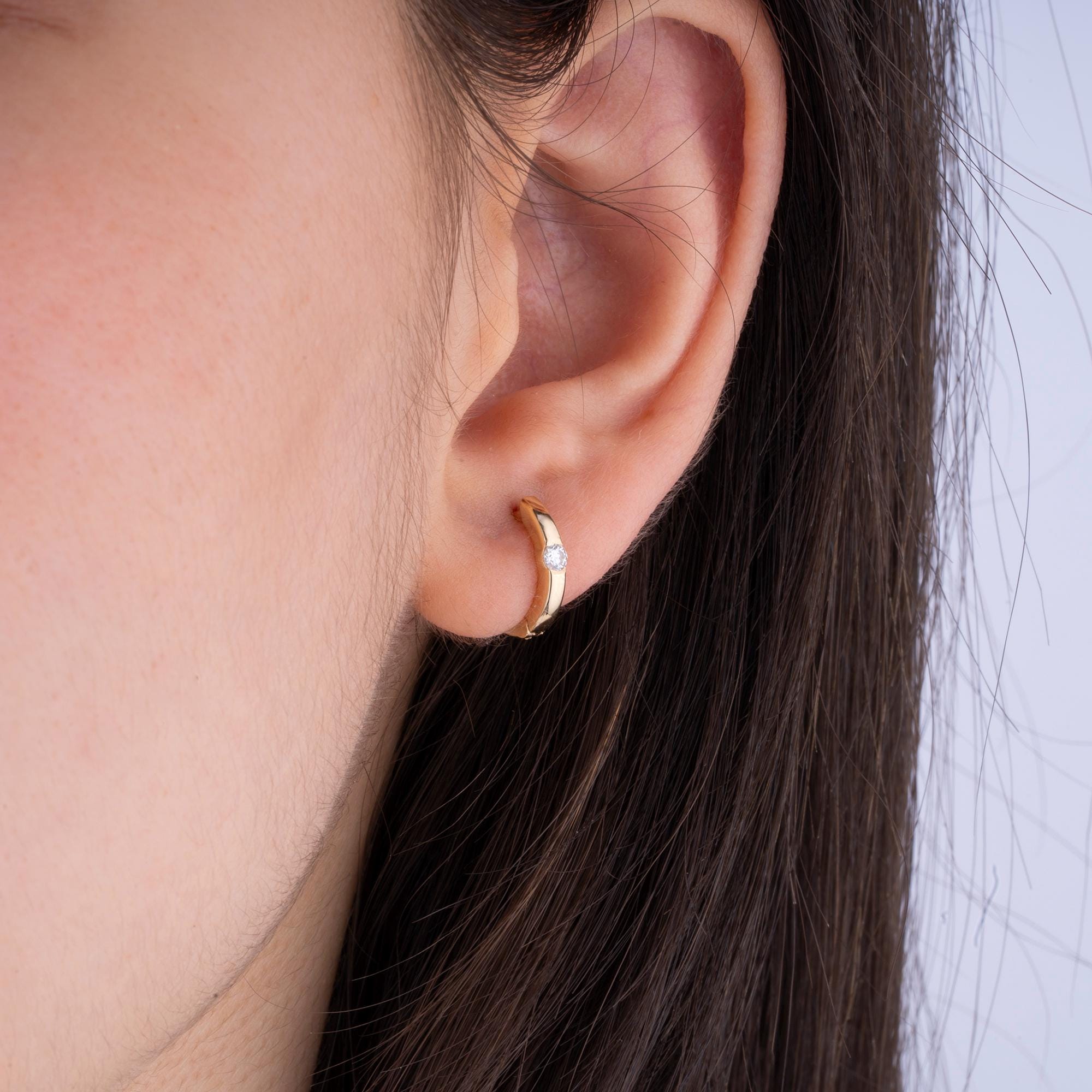 Minimalist gold hoop earrings with natural diamonds, handcrafted in solid 14K gold for a refined and luxurious look.