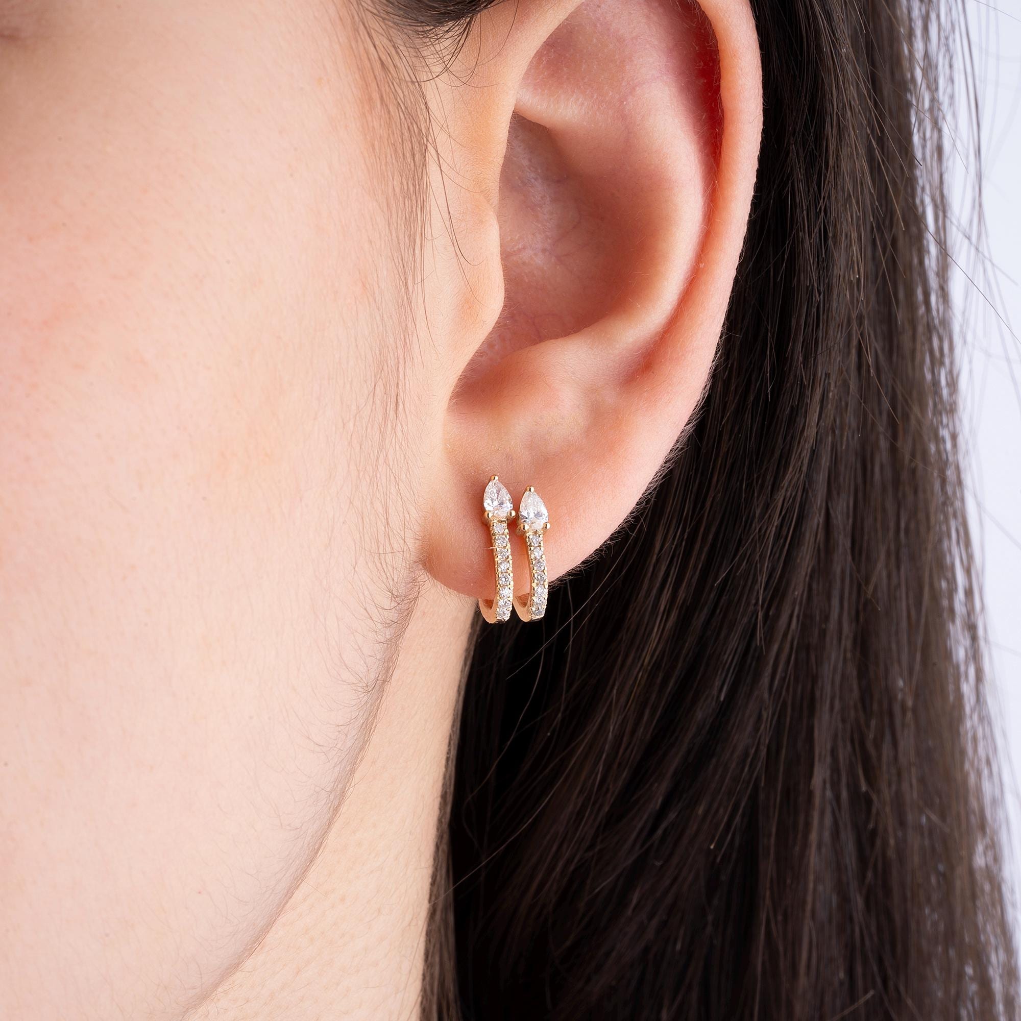 Dainty and elegant 14K gold diamond double huggie earrings, featuring round and pear-cut diamonds. A stunning addition to any jewelry collection, designed to elevate your style.